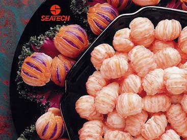 A photograph of cooked langostino meat in a bowl with shell on langostino on a plate surrounding the bowl.